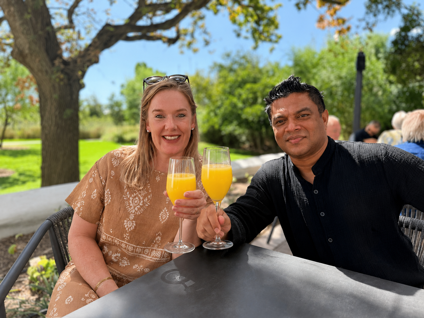 Nadine and Sobah toasting with glasses of sunshine